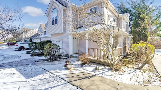 view of front of property featuring a porch and a garage