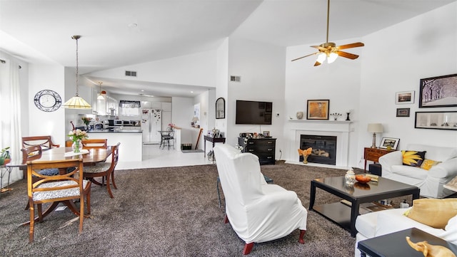 living room with tile patterned floors and high vaulted ceiling