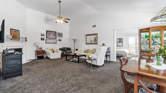 carpeted living room featuring ceiling fan and high vaulted ceiling