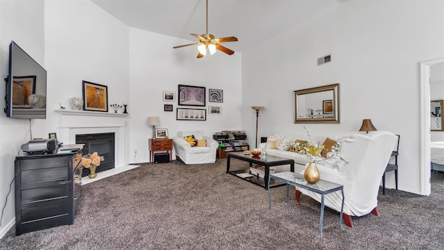 carpeted living room featuring ceiling fan and high vaulted ceiling