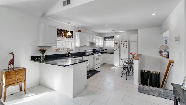 kitchen with sink, white cabinetry, pendant lighting, white appliances, and backsplash