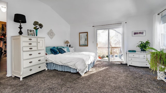 bedroom with lofted ceiling and dark carpet