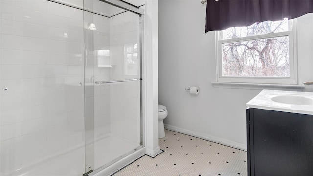 bathroom with vanity, tile patterned flooring, a shower with door, and toilet