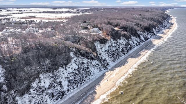 snowy aerial view with a water view