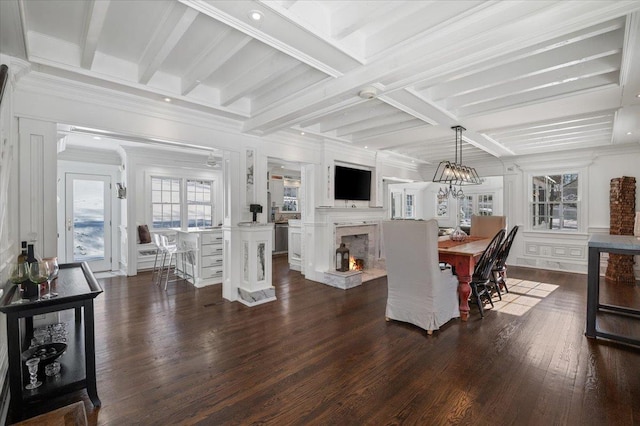 dining area with beamed ceiling, ornamental molding, dark hardwood / wood-style floors, and a chandelier