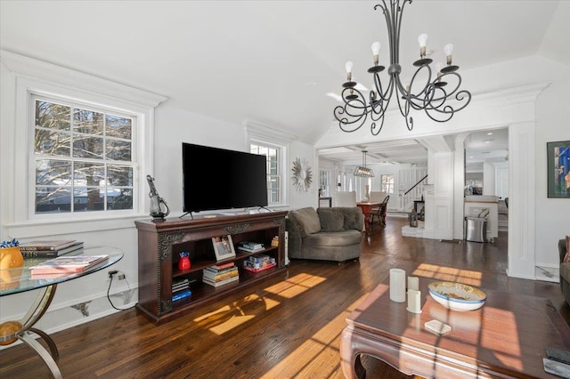 living room featuring vaulted ceiling, dark hardwood / wood-style floors, and a notable chandelier