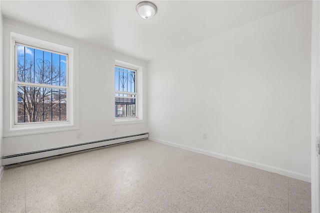 spare room featuring a baseboard heating unit