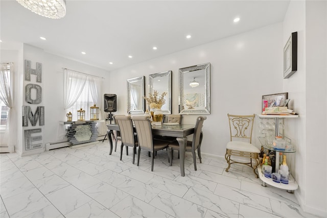 dining area with a baseboard radiator and a chandelier