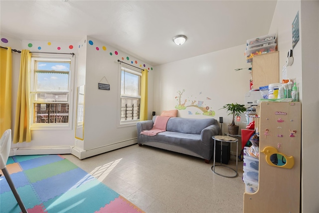 bedroom featuring multiple windows and baseboard heating