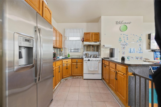 kitchen featuring stainless steel refrigerator with ice dispenser, white gas stove, kitchen peninsula, and light tile patterned flooring