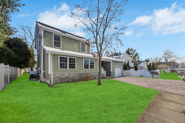 view of front of property featuring central AC unit, a garage, and a front yard