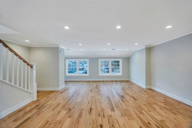 unfurnished living room featuring ornamental molding and light hardwood / wood-style flooring