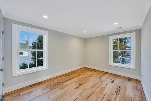 spare room featuring light hardwood / wood-style floors