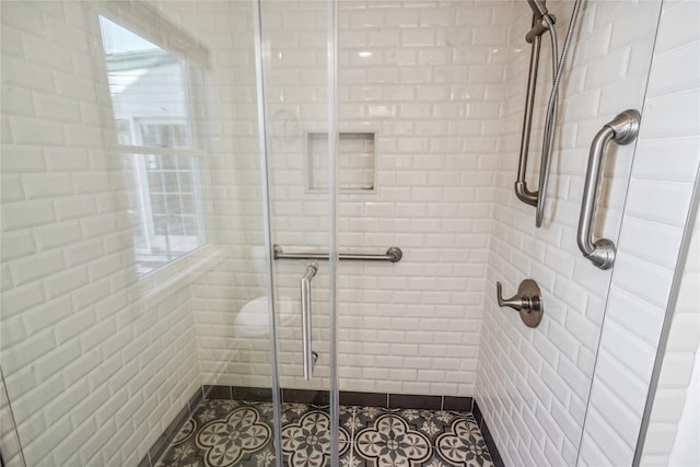 bathroom with tile patterned flooring and walk in shower