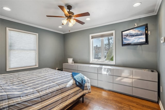 bedroom featuring ornamental molding, ceiling fan, and light wood-type flooring