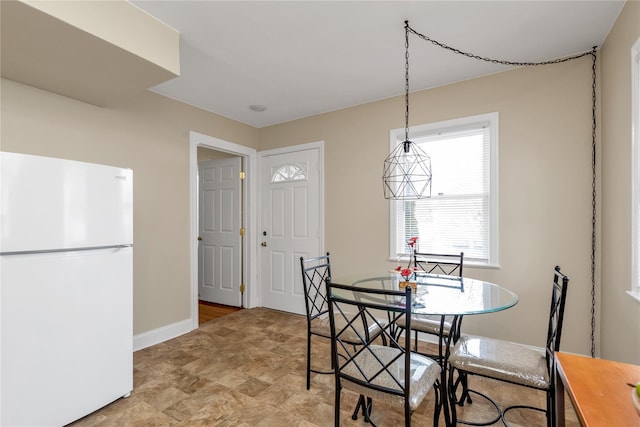 dining space featuring baseboards