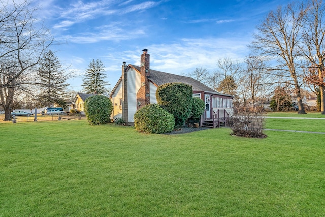 view of side of property with a lawn