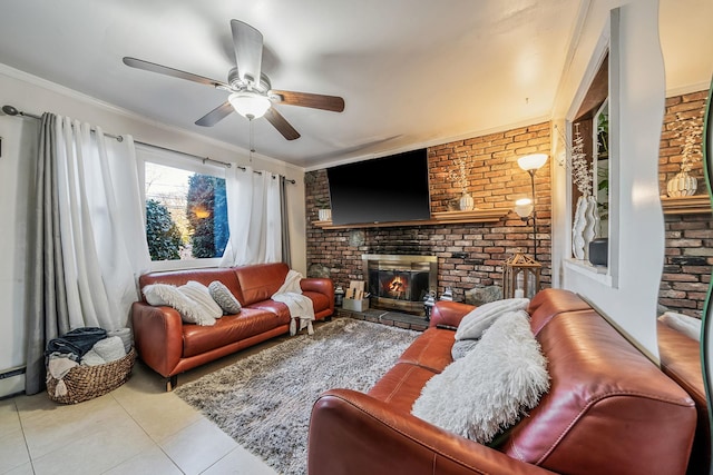 living room with crown molding, ceiling fan, brick wall, a brick fireplace, and light tile patterned flooring