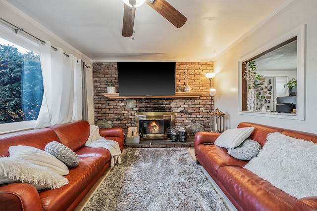 living room with ornamental molding, ceiling fan, and a fireplace