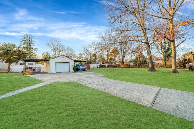 view of yard featuring a garage, an outdoor structure, and a carport