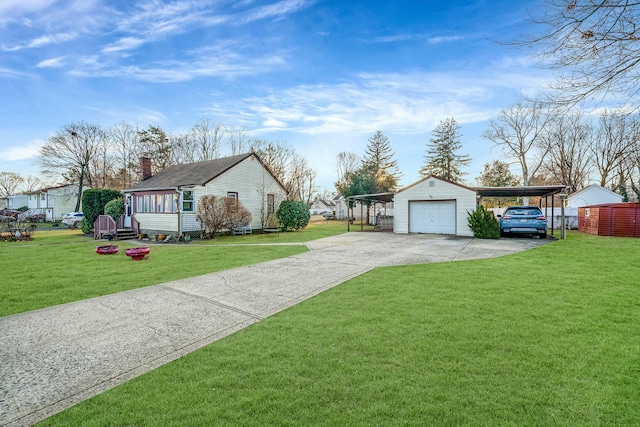 view of front of property with an outbuilding, a garage, a front yard, and a carport