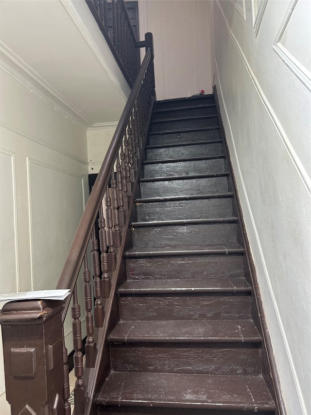 stairway featuring crown molding