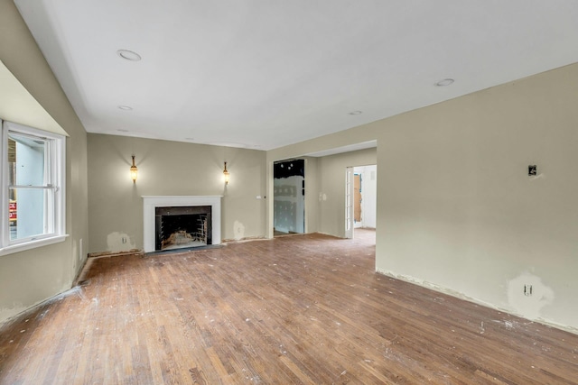 unfurnished living room featuring wood-type flooring