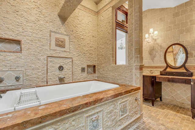 bathroom featuring vanity, tile walls, and tiled tub