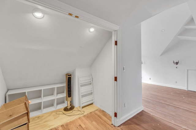 bonus room with lofted ceiling and hardwood / wood-style floors