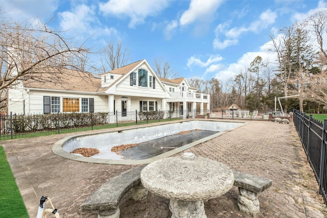 exterior space with an empty pool and a patio area