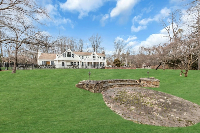 rear view of property featuring a yard