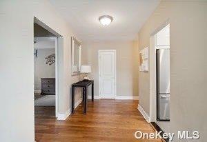 corridor featuring dark hardwood / wood-style floors