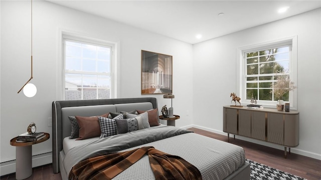 bedroom with dark wood-type flooring and baseboard heating