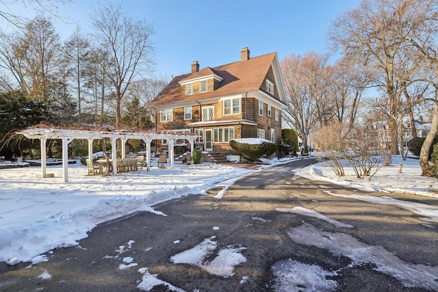 view of front of property with a pergola