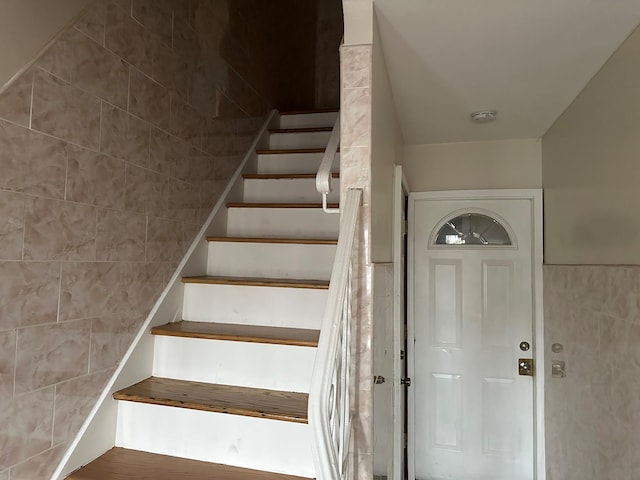 staircase with tile walls