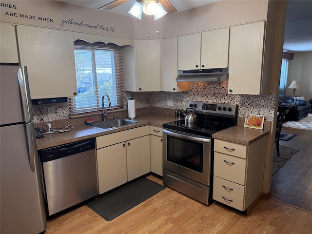 kitchen featuring stainless steel appliances, white cabinetry, sink, and light wood-type flooring