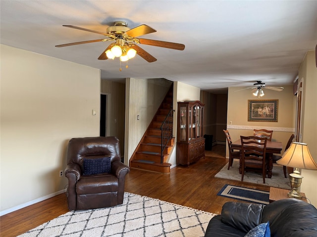 living room featuring a baseboard radiator, dark hardwood / wood-style floors, and ceiling fan