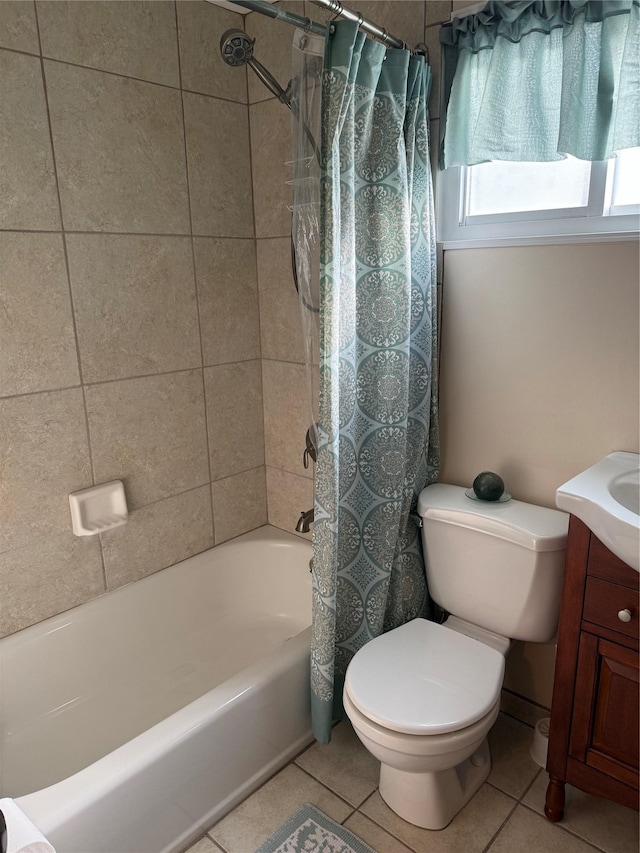 full bathroom featuring tile patterned flooring, vanity, toilet, and shower / bathtub combination with curtain