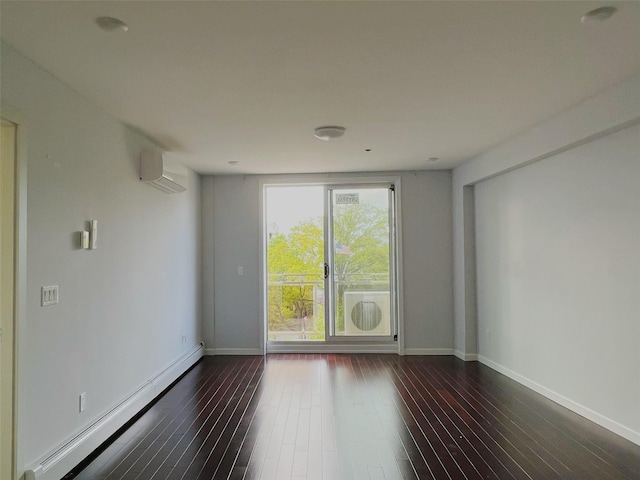 empty room featuring a baseboard heating unit, a wall mounted AC, and dark hardwood / wood-style floors