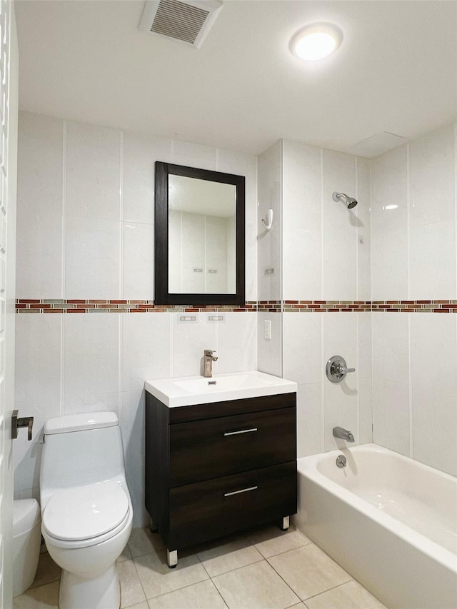 full bathroom featuring tile patterned flooring, toilet, tile walls, and  shower combination