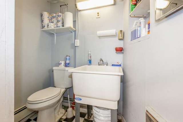 bathroom featuring a baseboard radiator, sink, and toilet