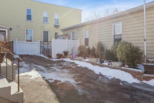 view of snow covered rear of property