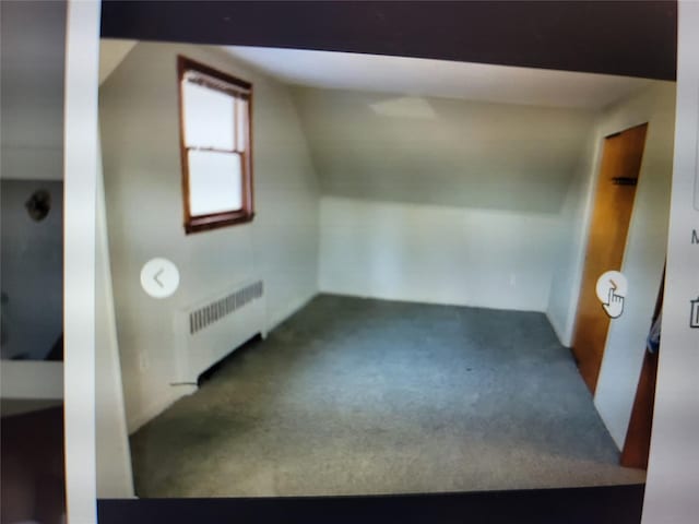 additional living space with carpet flooring and radiator heating unit