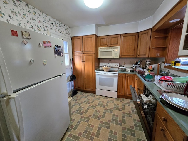 kitchen featuring white appliances and backsplash