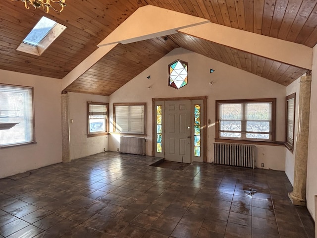 foyer entrance featuring a healthy amount of sunlight, radiator heating unit, and wooden ceiling