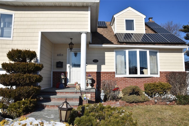 view of front facade with solar panels