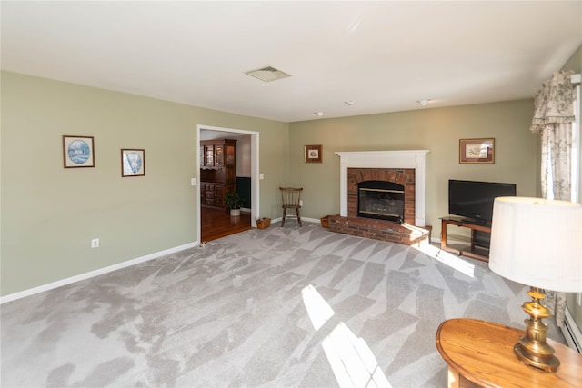 carpeted living room featuring a brick fireplace