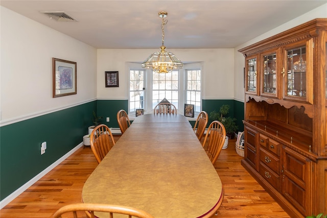 dining area featuring a chandelier and light hardwood / wood-style floors