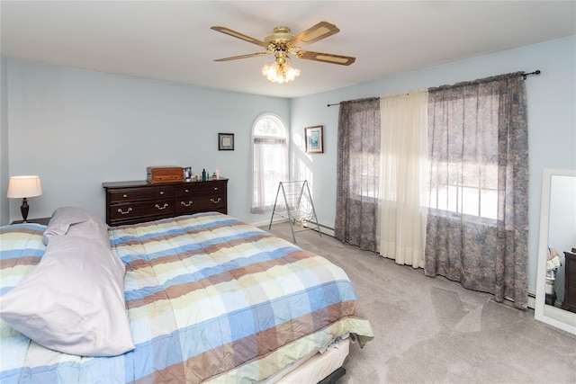 bedroom featuring light colored carpet and ceiling fan