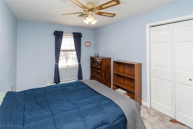 carpeted bedroom featuring a baseboard radiator, ceiling fan, and a closet